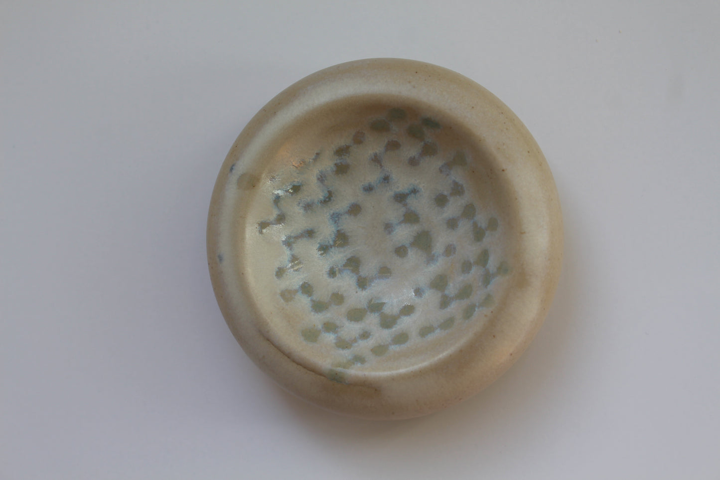 Small ceramic dish with textured surface on a white background